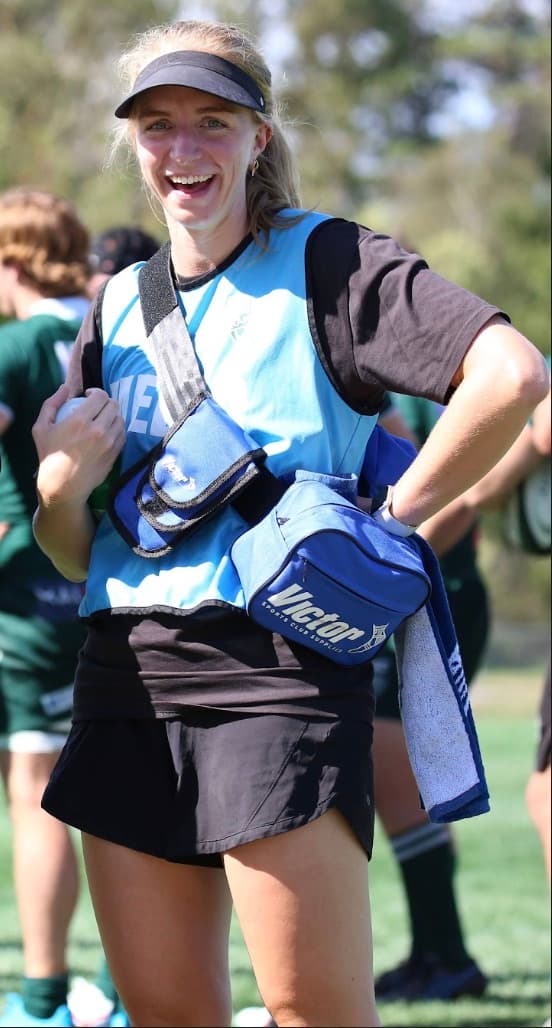 Eimear Keane pitchside with her physio kit bag at a sports competition