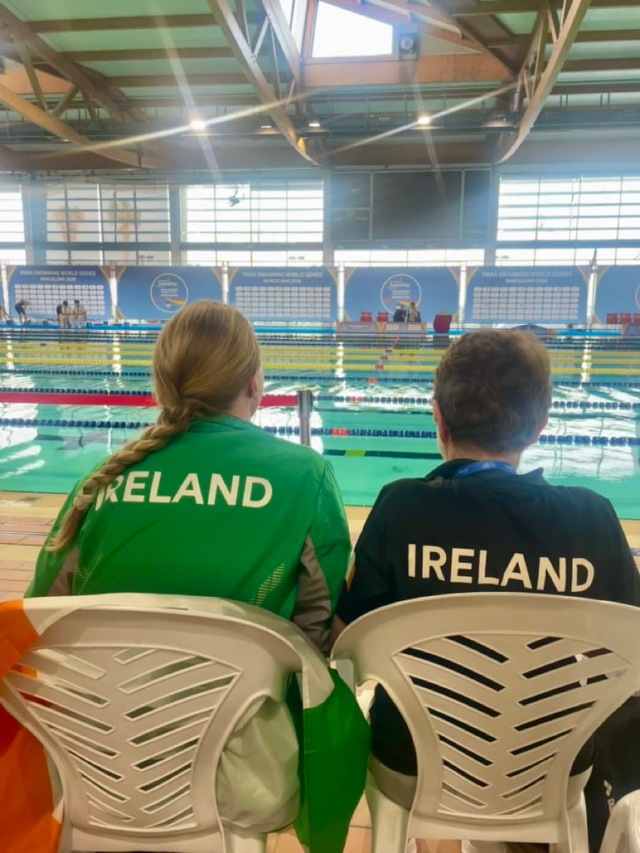 Eimear Keane in Ireland team kit poolside at the Para Swimming World Series, watching a session